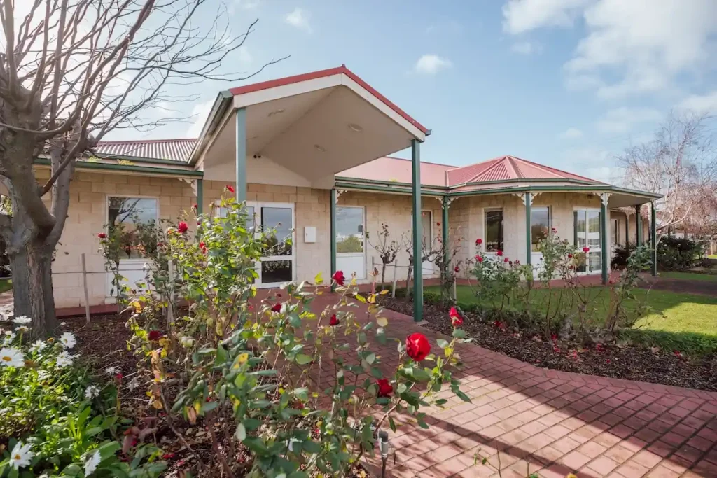 Red brick paved walkway and flowering rose gardens leading to the entrance of the East Geelong Small Chapel at 199 Ormond Rd, East Geelong.