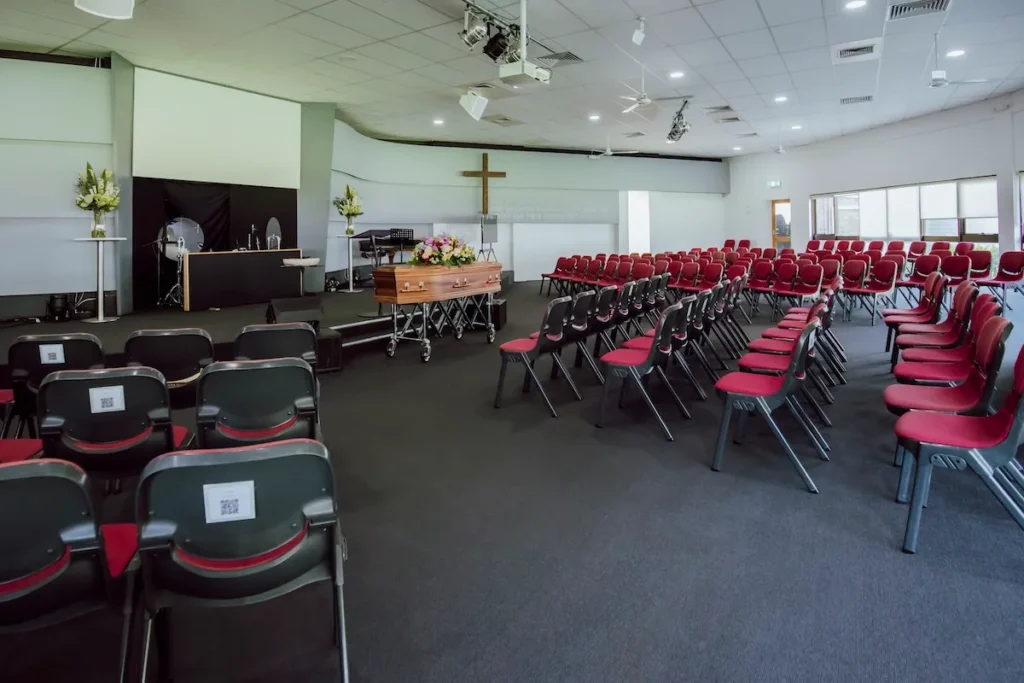 Wide interior perspective showing the modern seating rows, high ceilings, and stage setup available through Jonathan Hepner Funerals at 48 Waurnvale Dr, Belmont.